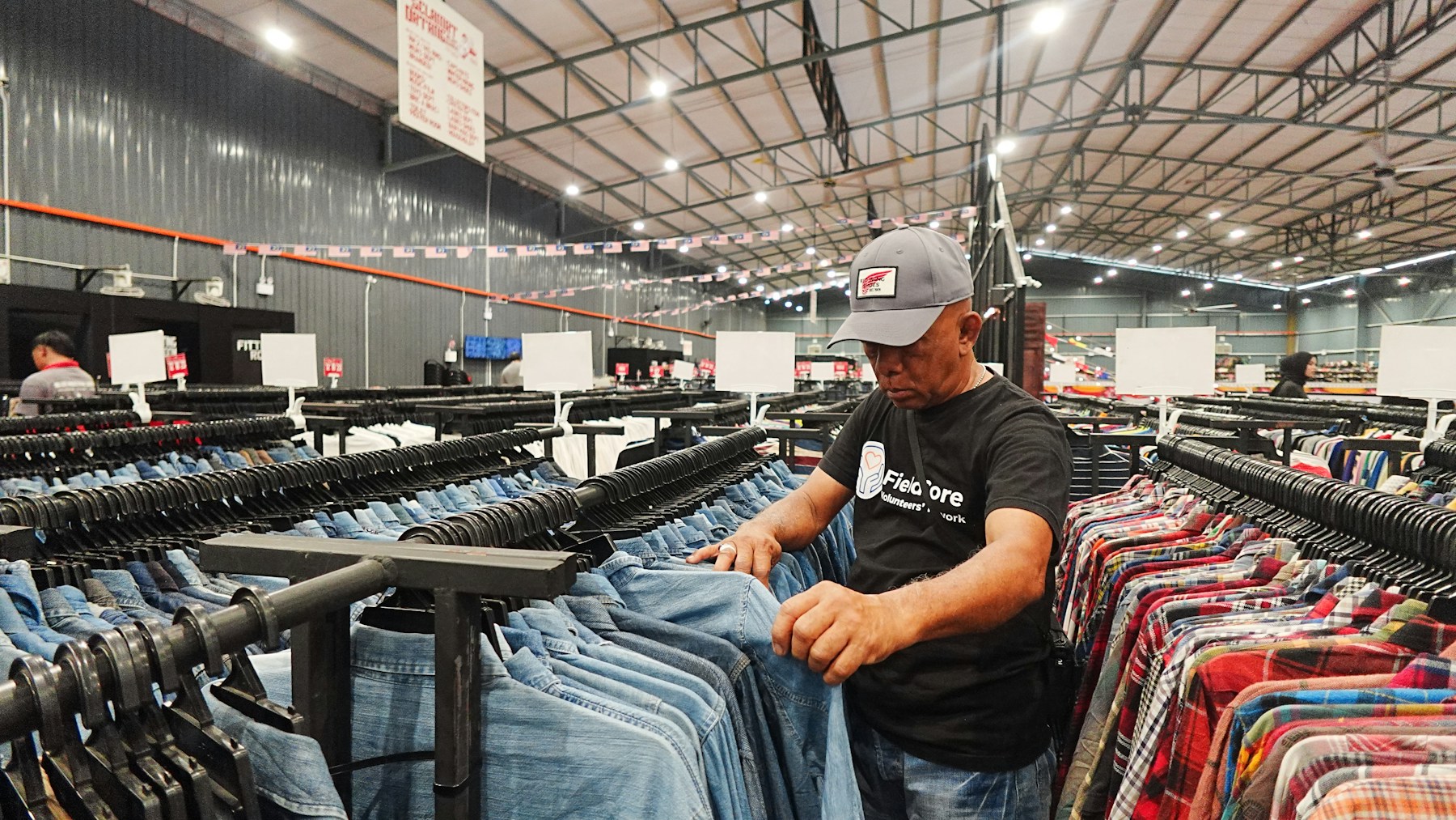 Man browsing clothes in a large retail store