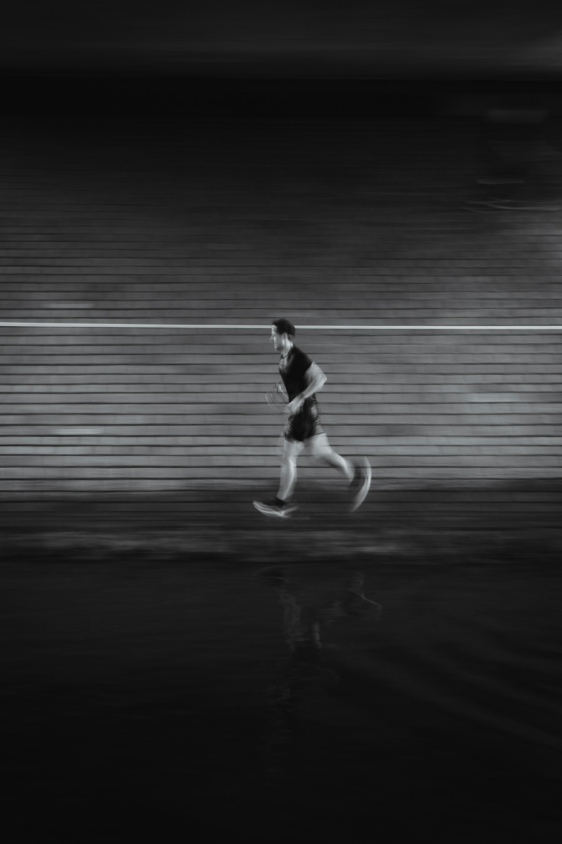 Man running on a track at night