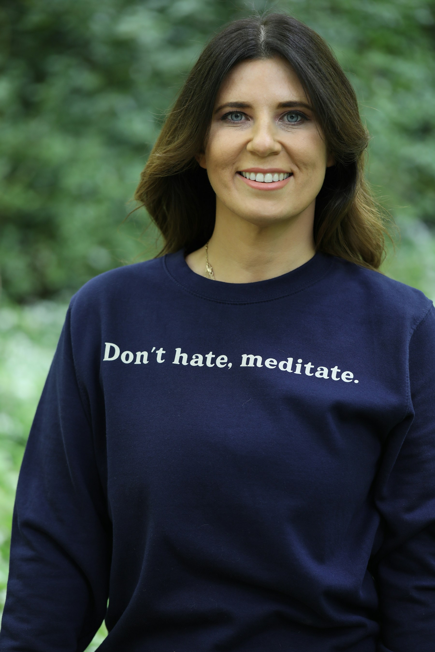 Woman wearing a sweatshirt with text